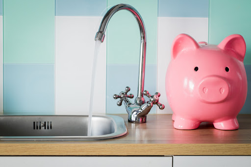 Piggy Bank Next To Kitchen Sink With Running Faucet Reminds Us To Take Care Of The High Water Bill.