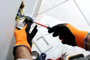 an Connors Plumbing, Heating and Air electrician fixing a Waseca, MN homeowners outlet