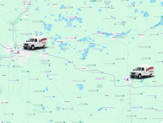 Map showing two delivery vans labeled "Capstone" positioned along a route between two towns, with various highways, lakes, and city names visible.